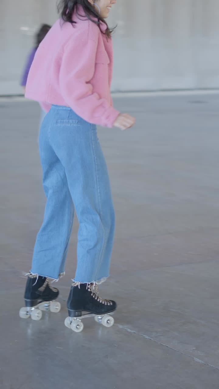 Woman in pink jacket dancing energetically in a large indoor space