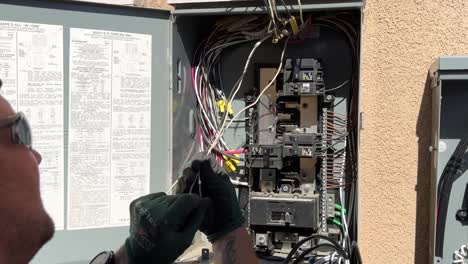 Electrician-Working-on-Power-Lines-in-Circuit-Box-After-Solar-Panels-Installation