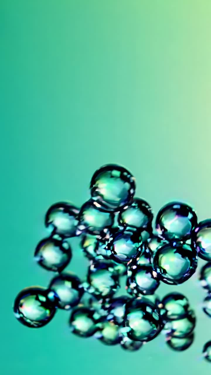 Close-up video of iridescent bubbles against a gradient blue-purple background, captured from a low