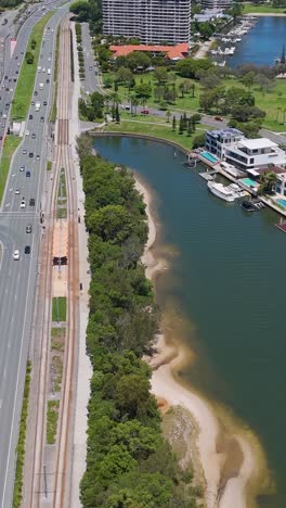 highway traffic near water and cityscape