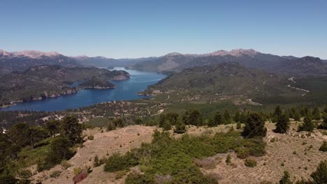 Aerial-view-over-the-lake-in-mountains-in-distance,-untouched-nature-during-sunshine-day-and-clear-weather,-captured-at-Patagonia,-Argentina,-South-America