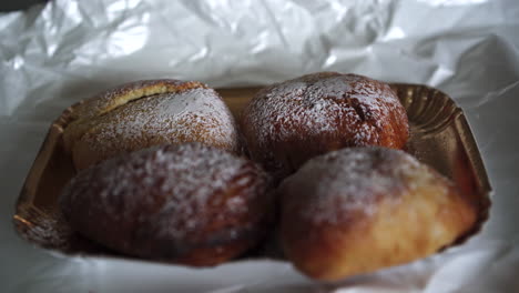 close up hand of woman with age spots picking up a traditional famous italian neapolitan pastry called sfogliatella napoletana 4k