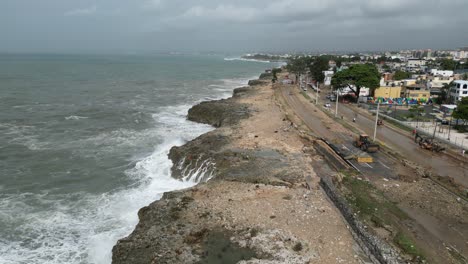 Aerial-view-of-ocean-waves-crash-against-the-rocky-coastline-of-Santo-Domingo-after-Hurrican-Beryl,-Dominican-Republic