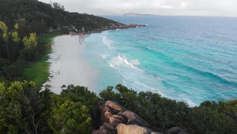 Aerial-view-of-the-white-beaches-and-turquoise-waters-at-Anse-Coco,-Petit-Anse-and-Grand-Anse-on-La-Digue,-an-island-of-the-Seychelles