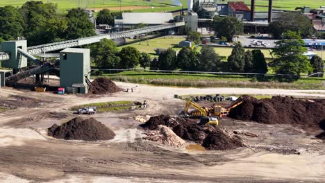 Aerial view of machinery operating at a sugar mill construction site under bright daylight