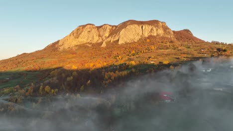 Flying-above-the-fog-near-the-famous-Buces-Vulcan-Mountain-situated-in-Hunedoara,-Romania