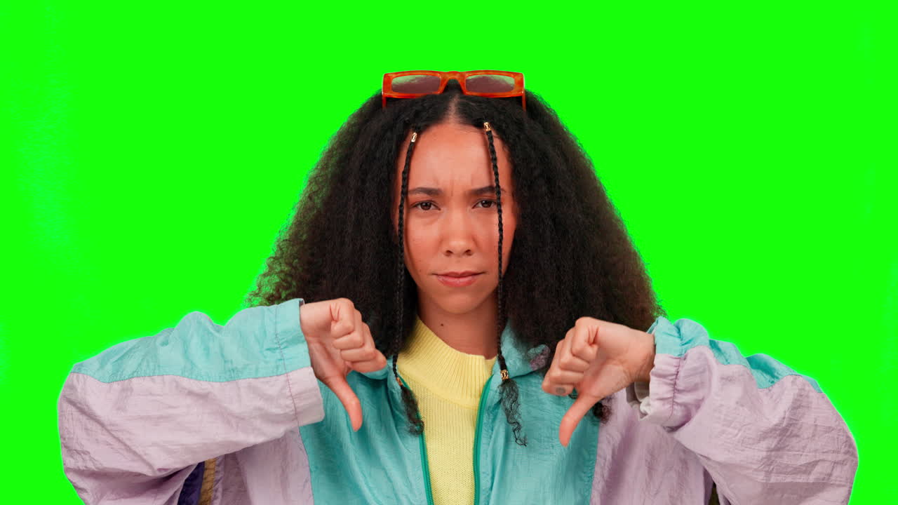 Young woman, thumbs down and disagree by green