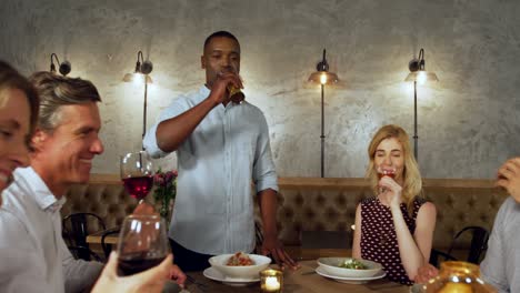 friends toasting drink glasses at a dinner party 4k