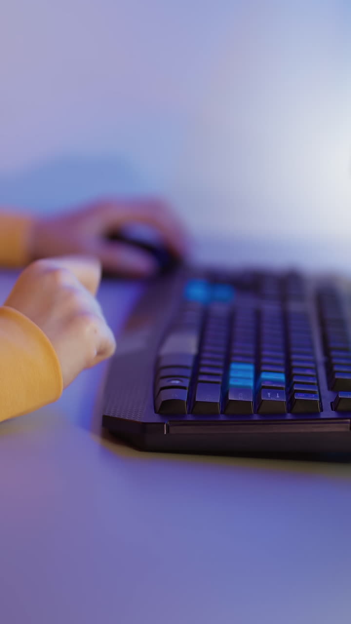 Young woman keyboarding on computer. Happy young woman sitting at room and using computer