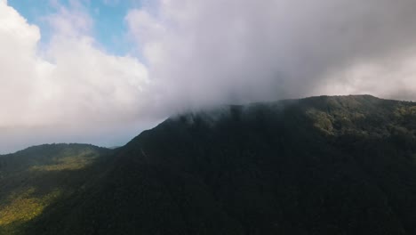 Low-hanging-white-clouds-move-slowly-on-the-wind-over-the-mountain-of-the-tourist-island-of-Koh-Phangan-on-a-sunny-day