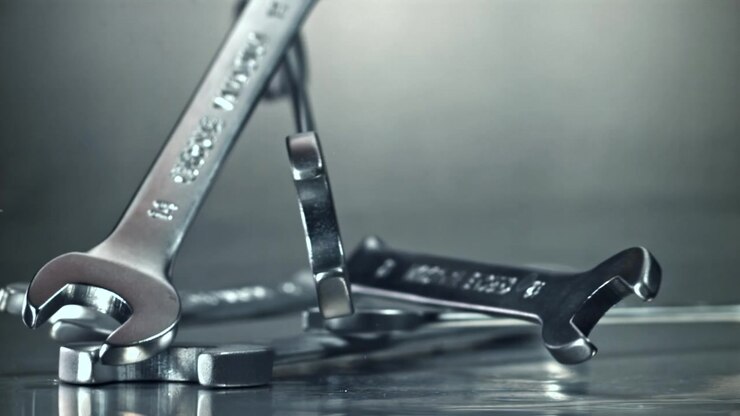 Metal Wrenches Falling in Slow Motion onto a Reflective Surface