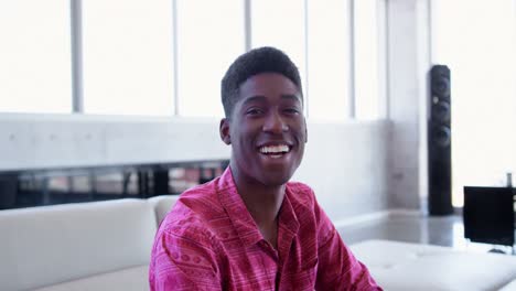 Handsome-African-american-male-executive-sitting-in-the-lobby-at-modern-office-4k