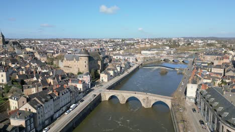 old bridge crossing mayenne river with laval castle