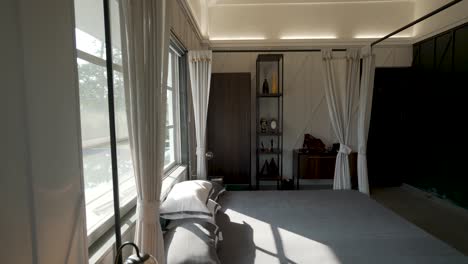 Bright-And-Comfortable-Bedroom-Interior-With-Bright-Morning-Sun-Through-The-Window---tilt-up-shot