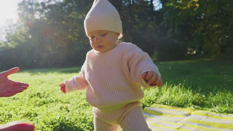 baby learning to walk in the park
