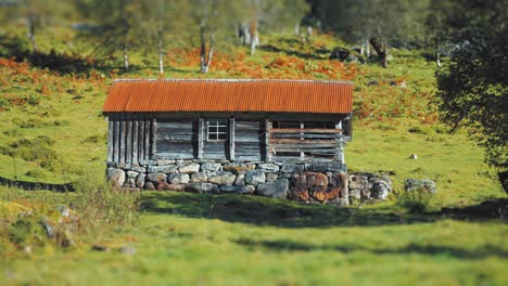 An-old-wooden-hut-at-the-mountain's-foothills