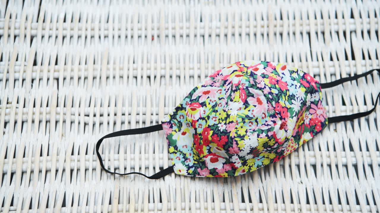 A panning tight shot of a floral face mask