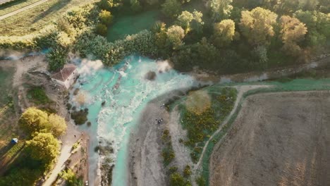 cascate del mulino, soothing natural hot springs bath, saturnia, tuscany, italy, europe, drone view traveling right