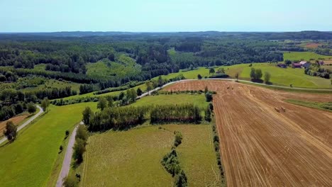 Aerial-Shot-of-Curvy-Country-Road-Surrounded-by-Fields-and-Trees