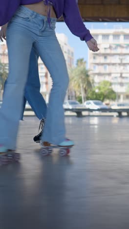 two people roller skating outdoors in an urban setting