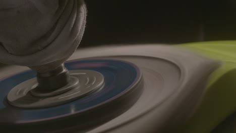 close-up of polishing machine buffing on a yellow car