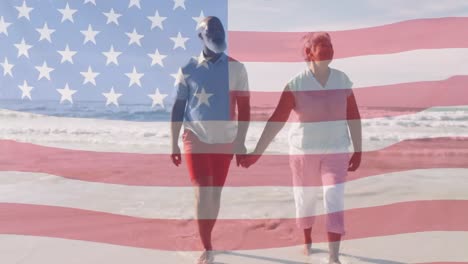 animation of happy senior african american couple walking at beach over american flag