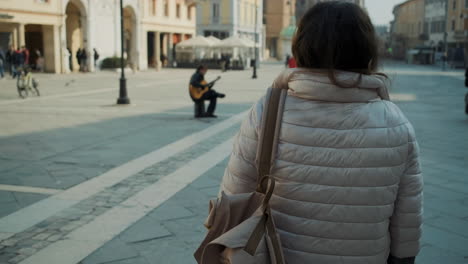 woman walking through a european city square