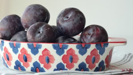 Plums in a decorative bowl