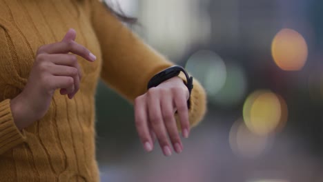 asian woman using smartwatch