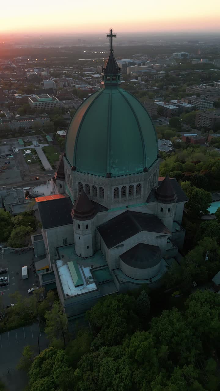 Aerial vertical shot around Saint Joseph Oratory in Montreal city at sunset during summer season, Quebec region, Canada