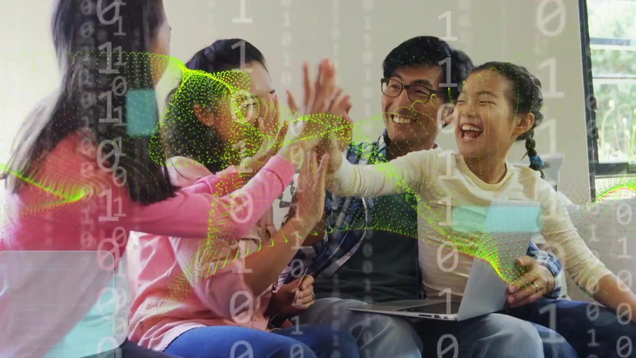 Family on couch watching laptop, high-fiving celebrating tech win while data sweeping across group