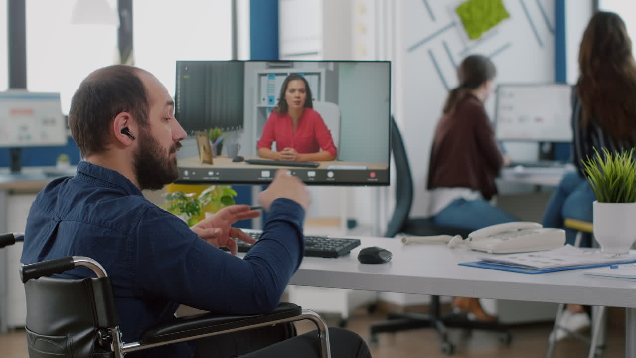 Handicapped manager talking on videocall with team leader
