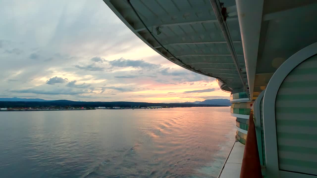 Sunset along Alaska's coast as seen from a cruise ship balcony - golden hyper lapse