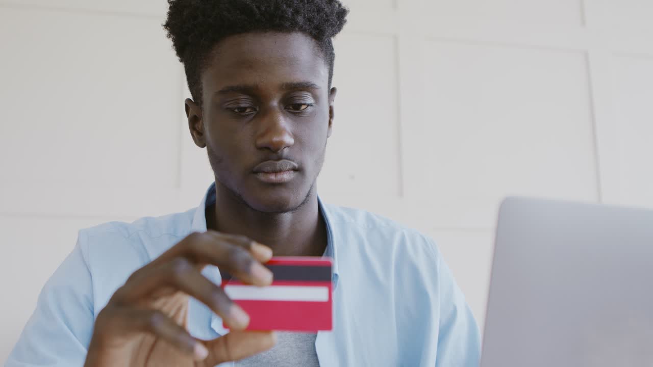 Man using credit card on laptop