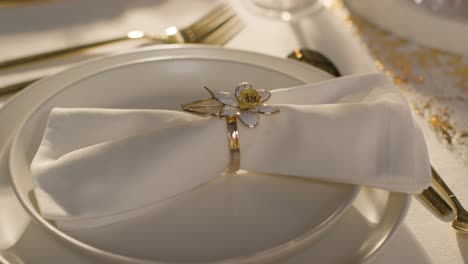 close up of napkin in ring on table set for meal at wedding reception