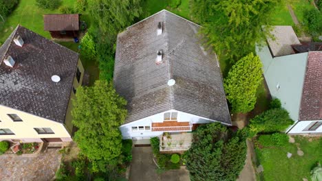 overhead view of houses topped with weathered eternit tiles in austria - aerial