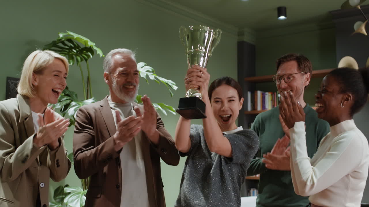 Diverse Business Team Celebrates Success with Trophy Award