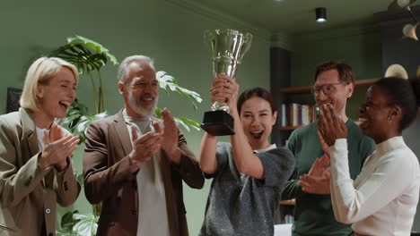 diverse business team celebrates success with trophy award