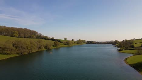 4k flying over hawkridge reservoir, drone moving to the left over the water revealing the fishing boats docks and the water dam wall, 60fps