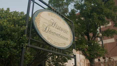 a sliding approach to the welcome sign for historic downtown in wilmington, north carolina in august on a clear day