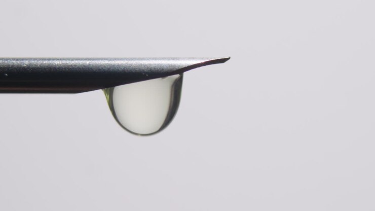 Macro Close-up of Hypodermic Needle Tip Dripping