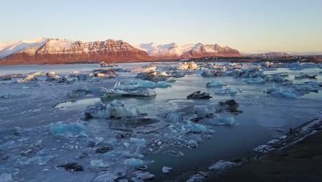 Icebergs-Floating-on-a-Lake-with-Mountainous-Background