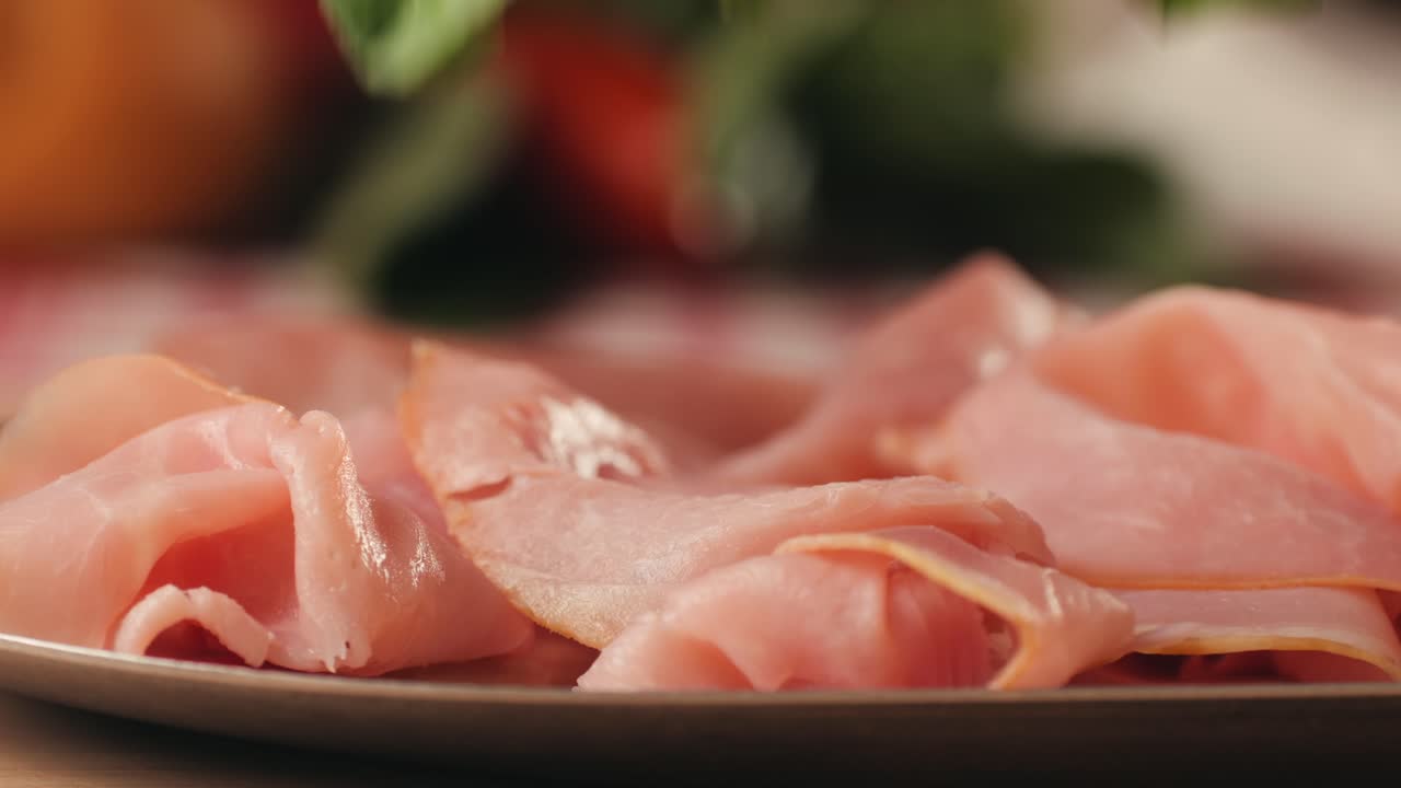 Ham italian mordatella, man Slices Of Traditional Italian antipasti mortadella sausage on a wooden cutting board, close up macro of chicken or turkey jamon, fat breakfast dish.