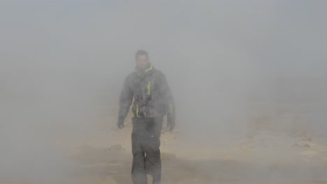 tourist man emerging from iceland's geothermal mist