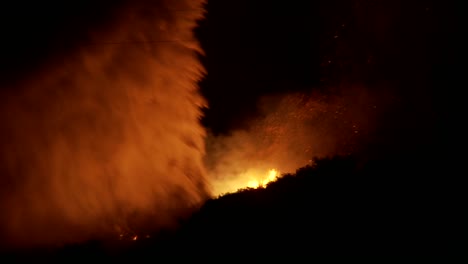 firefighters battle a raging california wildfire at night by performing a water drop from an aerial tanker 1