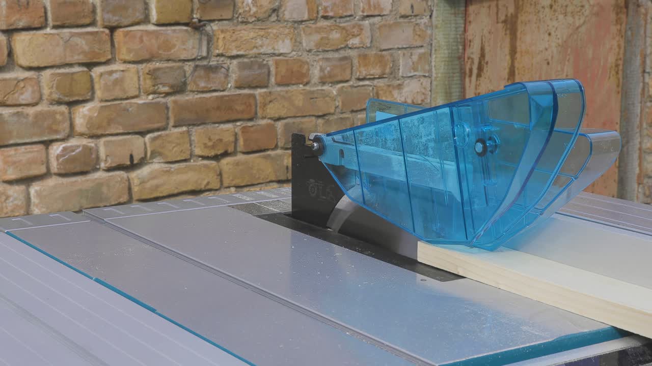 Handy man cutting wood on a table saw. Carpentry wood work.