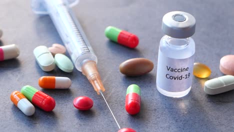 covid-19 vaccine, syringe, and medications