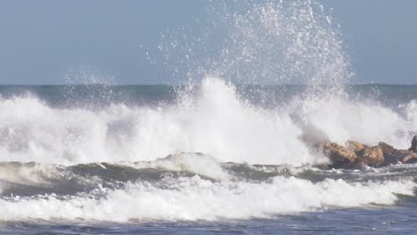 stormy seas breaking on rocks, slow motion seascape