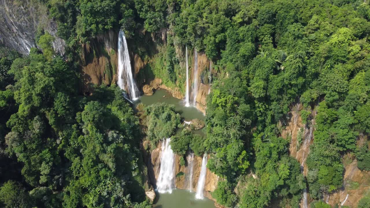 Drone shot flying away from Thi Lo Su Waterfall and seen from above, located deep in the jungle, off the beaten track of North Thailand in the area of Umphang in Southeast Asia