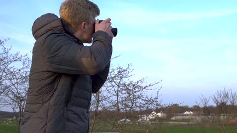 a tourist is taking photos while standing on a viewing platform